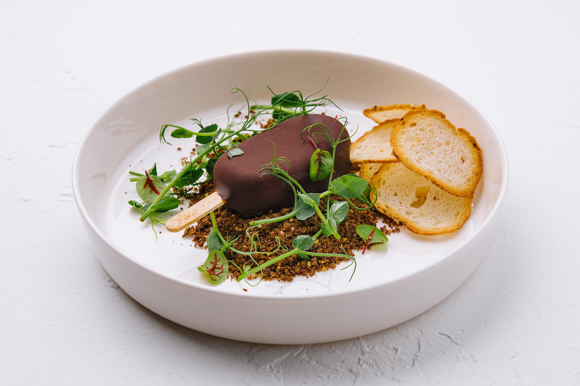 Plated main course on slate with herbs